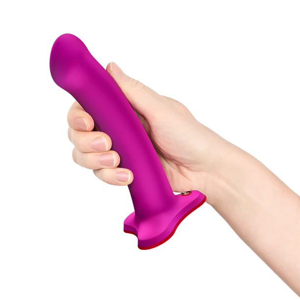 Hand holding a purple and red magnum g spot dildo against a white background