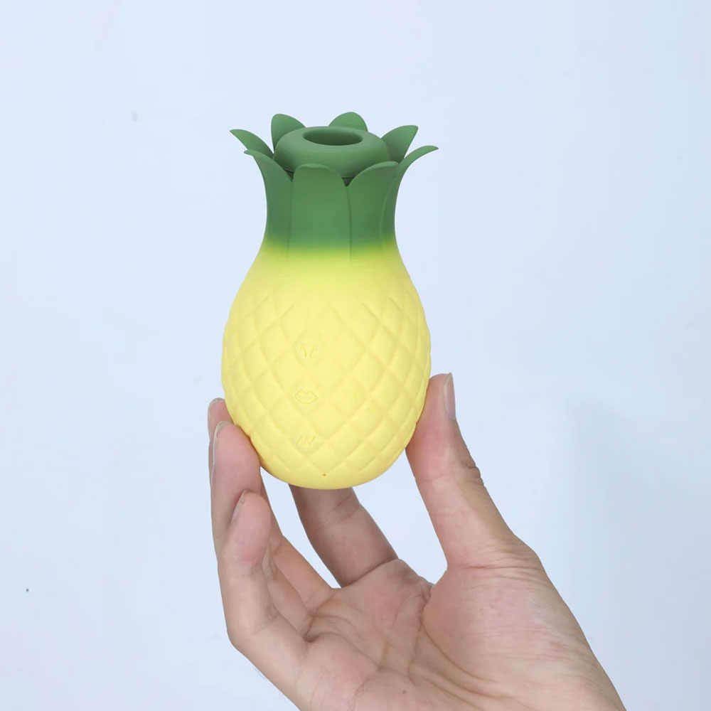 yellow pineapple clitoral sucker, held in hand 