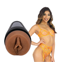 adult star xxalyna marie wearing yellow bra, panty and garter set, standing beside molded realistic vagina masturbator