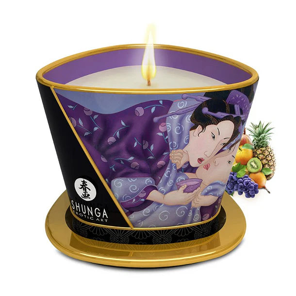 Shunga candle with artistic design and visible flame on a white background