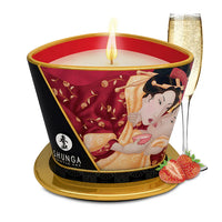 Shunga candle with geisha design, a glass of champagne, and strawberries on a white background
