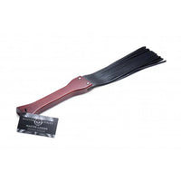 Master Lasher flogger with brown handle and black  tassels on a white background