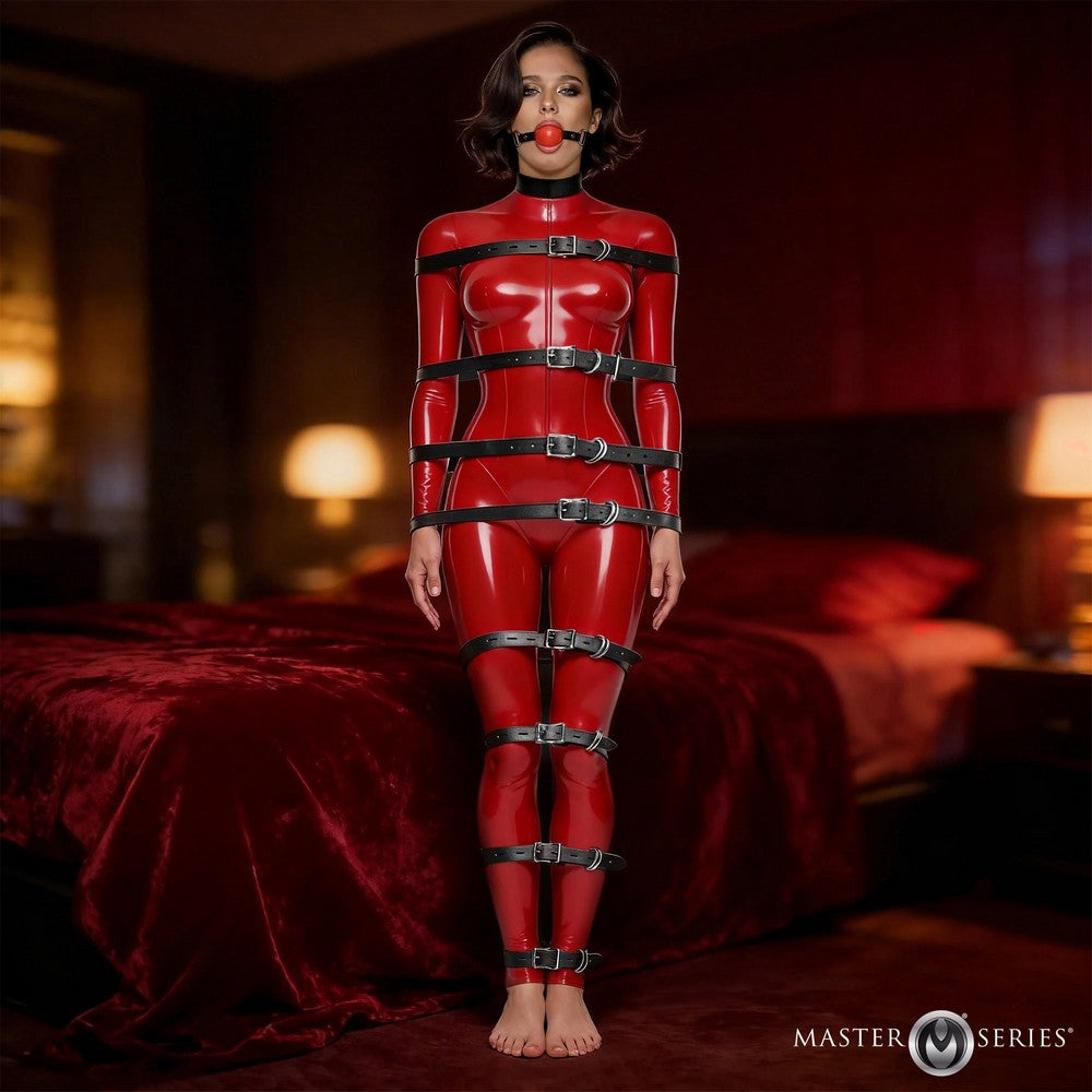 Person wearing a red latex outfit with black straps in a dimly lit room.