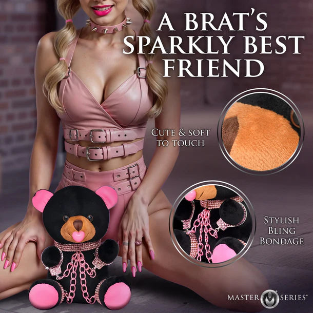 Person holding a plush toy with decorative chains, labeled 'A Brat's Sparkly Best Friend' by Master Series.