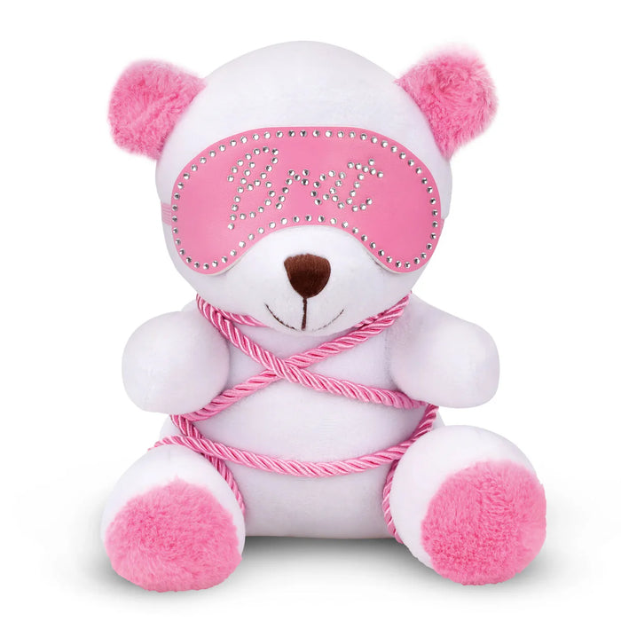 White teddy bear with pink accents and a pink blindfold on a white background