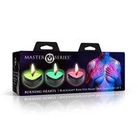 Master Series Burning Hearts Blacklight Reactive Heart Drop Candle Set of 3 in its retail packaging, featuring three glowing candles (green, blue, and pink) on a white background.