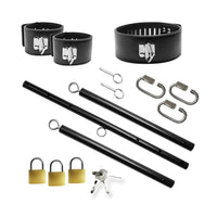 A black restraint kit with metal bars, cuffs, padlocks, keys, and rings, displayed on a clean white background.