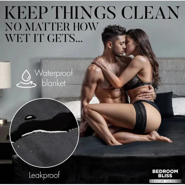 couple in a romantic setting on bed with black waterproof blanket