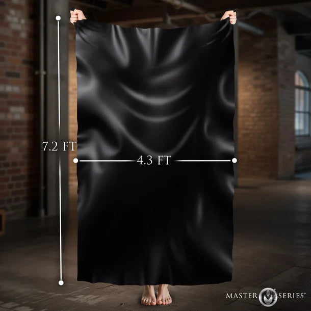 Black pvc being held up with measurements in a dimly lit room.