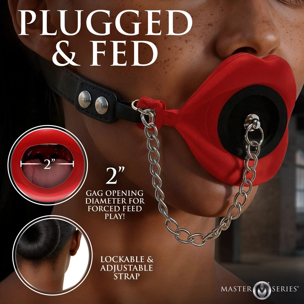 Red gag with black gag and lockable strap on a person, featuring 'Plugged & Fed' text and Master Series branding.