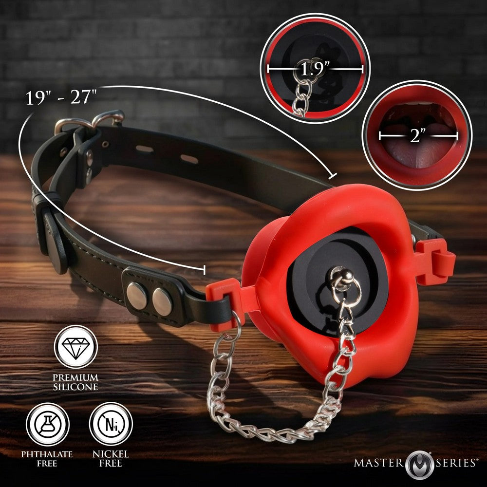 Black leather gag with red retractable leash on a wooden surface, showing measurements and product features.