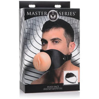 a black and grey display box depicting a man wearing a large gag with a penetrable vagina into the mouth and black straps 