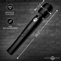 Black wand device with measurements and features on a dark brick wall background