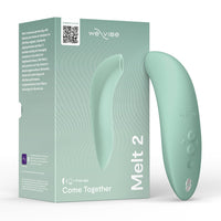 we vibe melt 2 vibrator with clitoral sucking and vibration beside box packaging in green