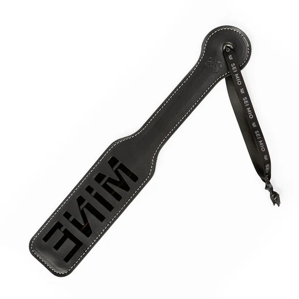 Black leather paddle impression with the word mine branding on a white background