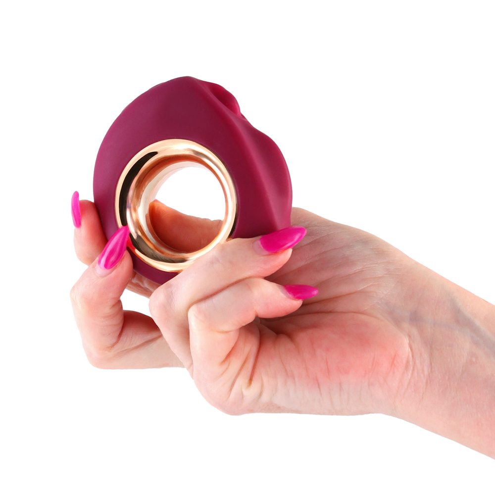 red & gold minerva gold n dreams clitoral vibrator held in hand