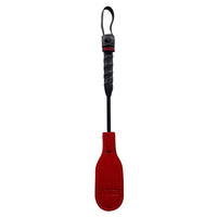 Red paddle with black handle on a white background