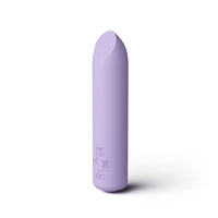 A lavender purple curved silicone personal care device, standing vertically on a white background with a soft shadow.