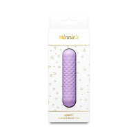A packaged purple textured bullet vibrator in a white box with gold lettering and heart patterns, labeled 'minnie's spark'.