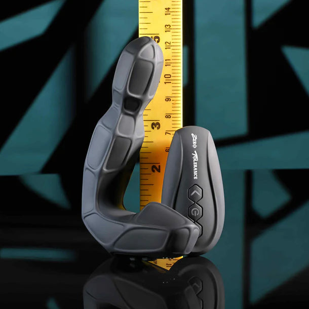 Zero Tolerance Mr. Prostate silicone anal plug with a measuring tape showing measurements against a dark background
