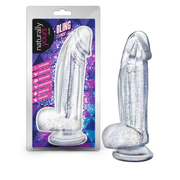 Clear glittery dildo with balls with packaging labeled 'Naturally Yours' on a white background