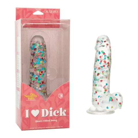 a clear penis shaped dildo with confetti hearts inside, balls and a suction cup. Shown next to its red plastic display box 