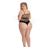 Woman wearing a black strappy swimsuit on a white background