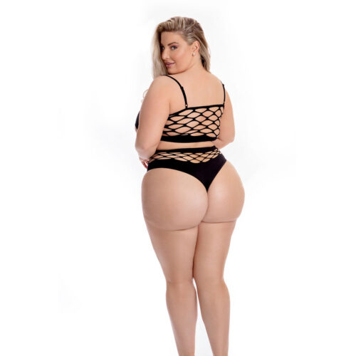 Woman wearing a black strappy swimsuit on a white background