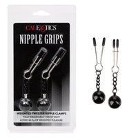 silver nipple tweezers with connected black weights next to package