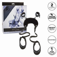 black thigh to neck pillow restraing with attachable cuffs on the pillow beside packaging