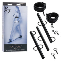 black nocturnal collection spreader bar with ankle cuffs beside box packaging