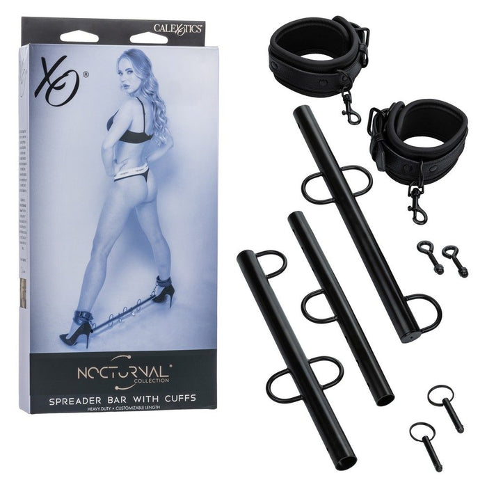 black nocturnal collection spreader bar with ankle cuffs beside box packaging
