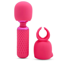 Pink silicone massage with attachment with textured design on a white background