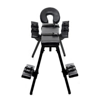 Black adjustable bondage chair with armrests and footrests, with restraints on a white background