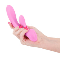 Hand holding a pink rabbit-shaped vibrators on a white background