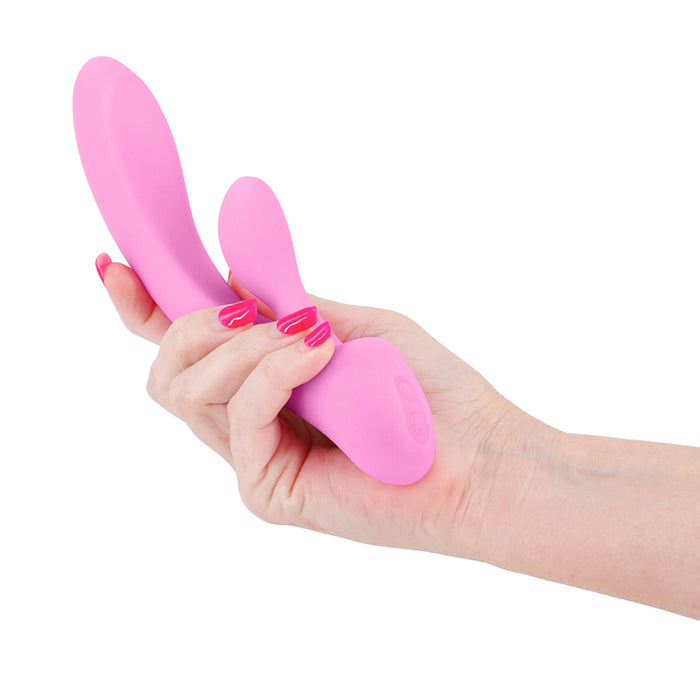 Hand holding a pink rabbit-shaped vibrators on a white background