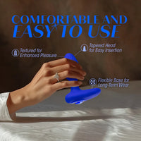 blue vibrating butt plug with rounded head, bottom base, blue gem on bottom, with hand holding the anal plug