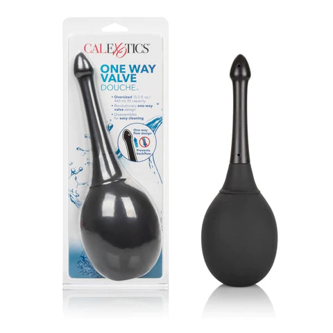 a large black bulb douche with a black nozzle that has a pointed tip, shown next to its plastic packaging