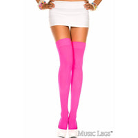 Person wearing bright pink knee-high socks on a white background
