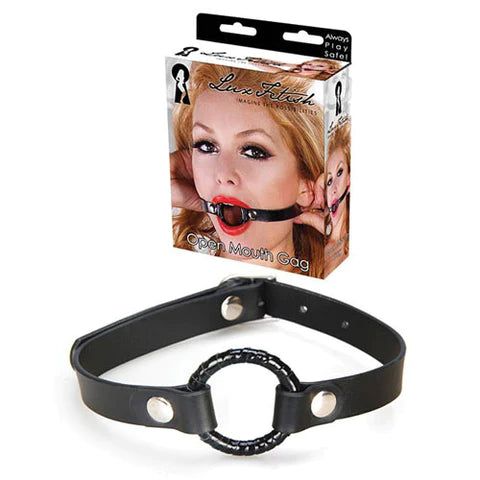 a black ring with black straps and silver fasteners. Shown next to its display box that depicts a woman wearing the open mouth gag