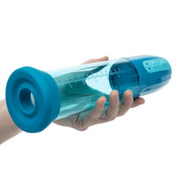 Hand holding a blue and clear penis pump with measurement markings on a white background