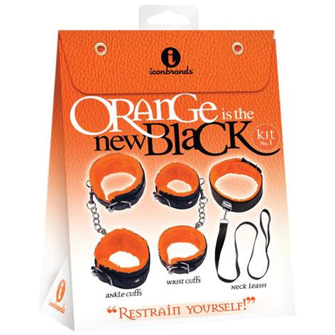 an orange display box depicting a black leash, a black collar with fluffy orange lining and two sets of black cuffs with attached chains and fluffy orange lining