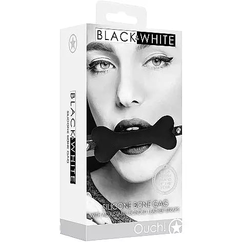 a black and white box depicting a woman wearing a black bone shaped gag with black straps