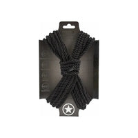 japanese bondage rope on carboard backing, rope displayed in the shape of an x . in black