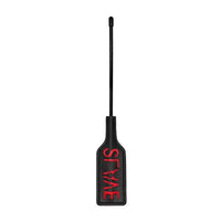 a black stick with a small paddle on the end with the word slave written in red letters