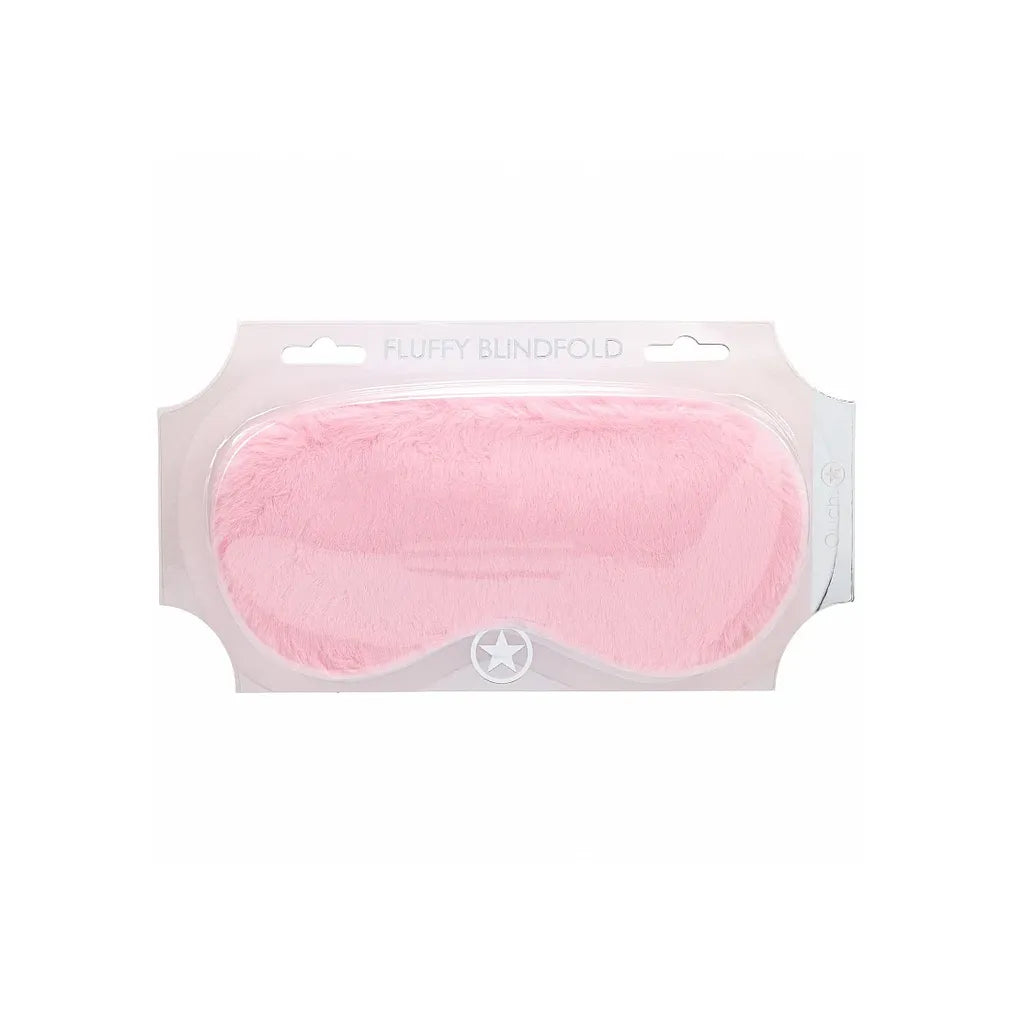 Pink fluffy blindfold in packaging on a white background