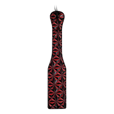 a red and black paddle with a shiny pattern on it