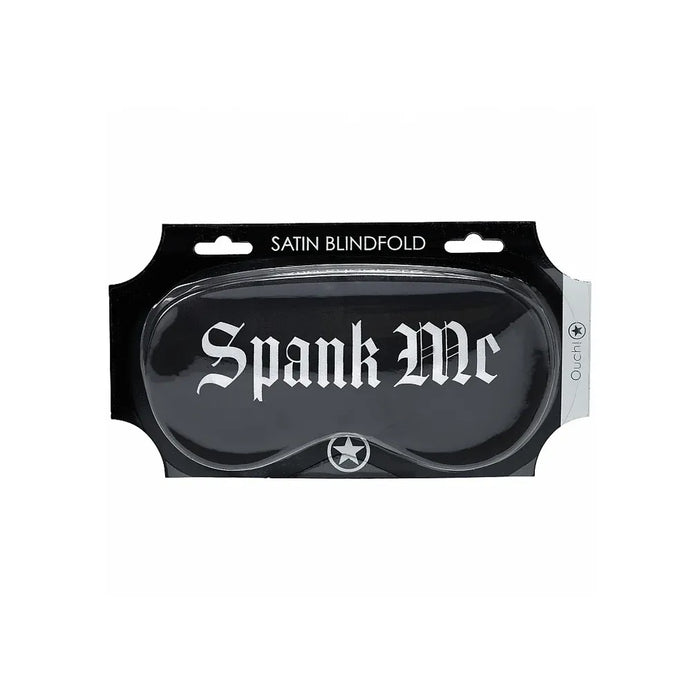 Black satin blindfold with 'Spank Me' branding in packaging on a white background