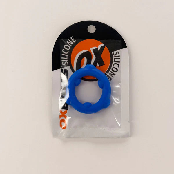 A blue silicone ring-shaped product in its original retail packaging, featuring a black and white header card with an orange logo.