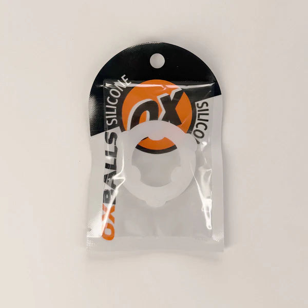 A white circular silicone ring accessory in a clear plastic blister pack with a black and orange header card. The packaging features the text 'OX SILICONE' and 'OX BALLS'.